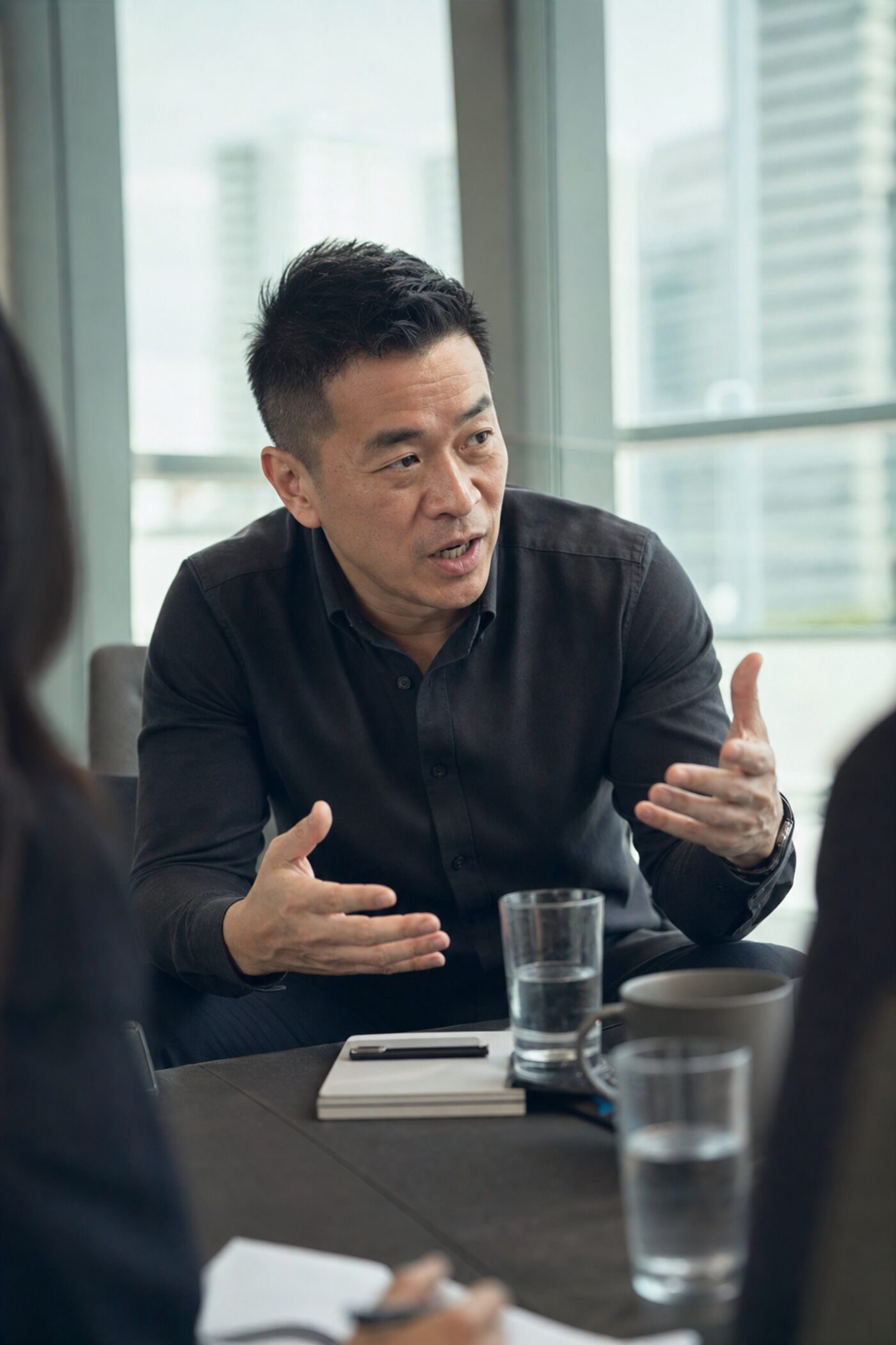 A consultant mid-conversation in a meeting room