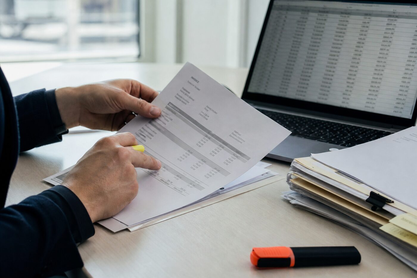 Cross-checking figures between a printed invoice and a laptop